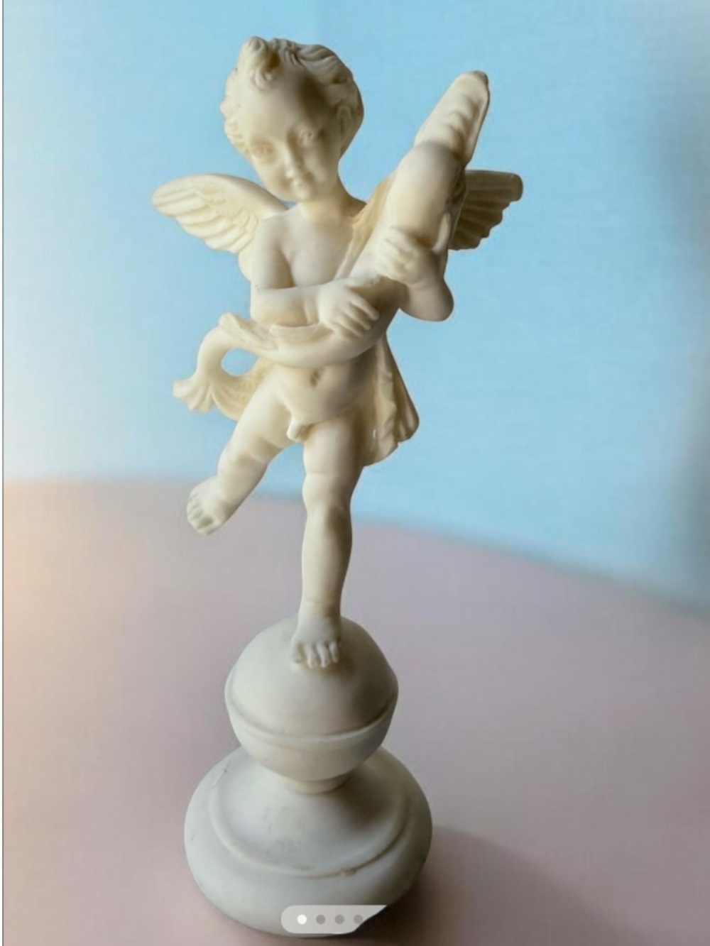 an A. Santini sculpture of a cherub made in Italy